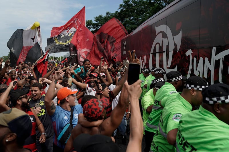 Flamengo supporters alongside the team bus at the international airport in Rio de Janeiro. AP