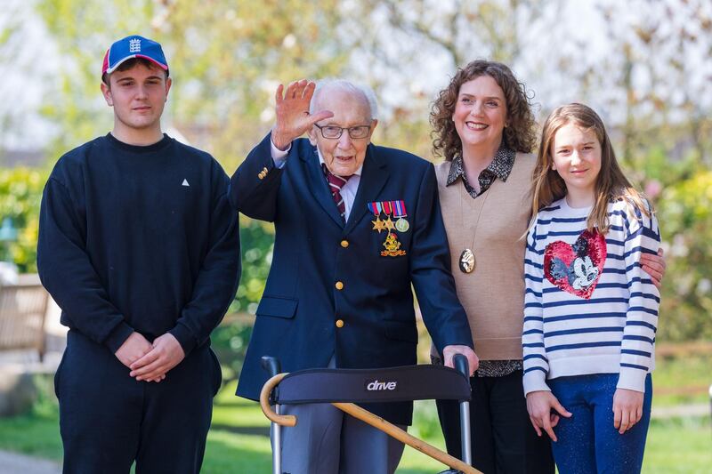 Then 99-year-old British veteran Captain Tom Moore with grandson Benji (L), daughter Hannah Ingram-Moore (2-R) and granddaughter Georgia (R) outside his home after completing the 100th length of his back garden. EPA