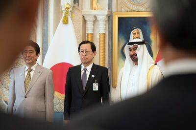 ABU DHABI, UNITED ARAB EMIRATES - April 30, 2018: HH Sheikh Mohamed bin Zayed Al Nahyan, Crown Prince of Abu Dhabi and Deputy Supreme Commander of the UAE Armed Forces (R), stands for a photograph with HE Shinzo Abe, Prime Minister of Japan (L) and a UAE-Japan Business Forum delegate (C), during a reception at the Presidential Palace.

( Mohamed Al Hammadi / Crown Prince Court - Abu Dhabi )
---