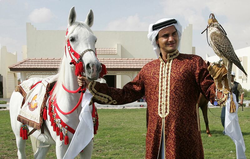 Roger Federer holds a falcon during a photo shoot in Doha  in 2006. AFP
