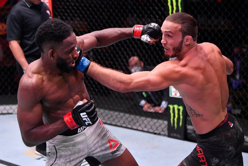 Anthony Rocco Martin punches Neil Magny in their welterweight bout during UFC 250. Reuters