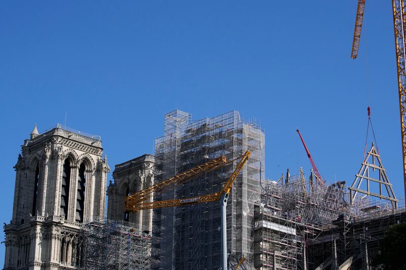 A crane lifts a huge oak frame at Notre Dame. AP