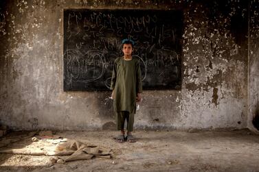 Rahmatullah, 10, poses in a classroom at Shahid Niamatullah Primary School in Panjwayi district, formerly occupied by ISAF and the Afghan National Police. Having lost his father to the war, he says he continues to hear the sounds of bullets at night.