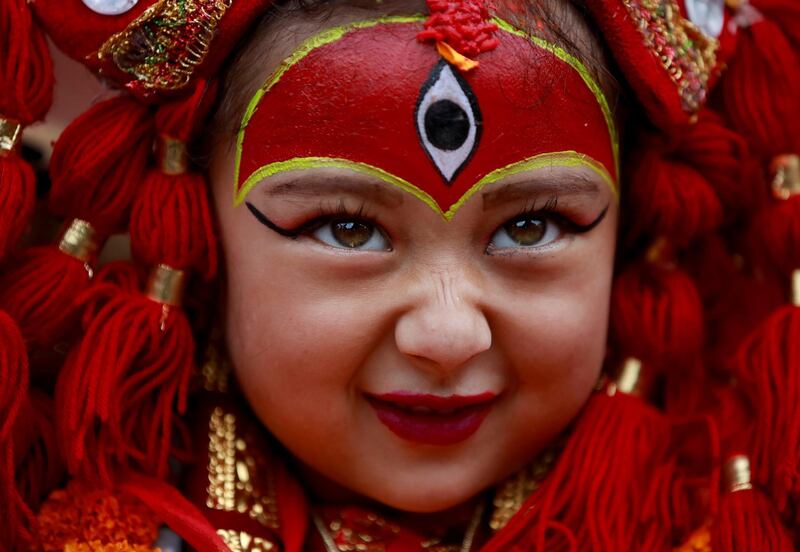 A young girl dressed as the Living Goddess Kumari participates the Kumari Puja festival, in which young girls pose as the Living Goddess Kumari and are worshipped by people in belief that their children will remain healthy, in Kathmandu, Nepal. Reuters