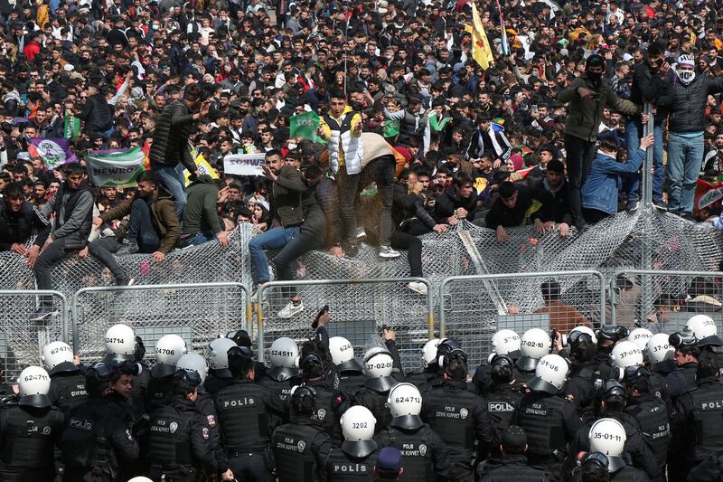 Riot police fire pepper spray into the Nowruz crowd in Diyarbakir, Turkey, as revellers protest against the arrest of demonstrators. Reuters