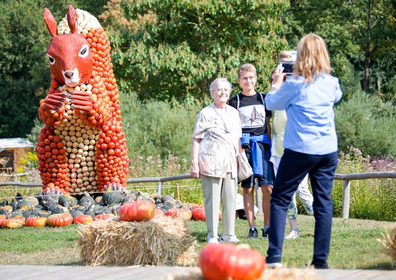 Visitors take pictures of themselves in front of a squirrel. AFP