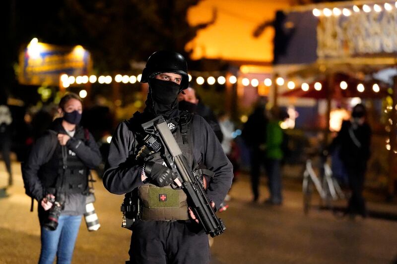 A person carries a gun while marching on the night of the election, in Portland, Oregon. AP Photo