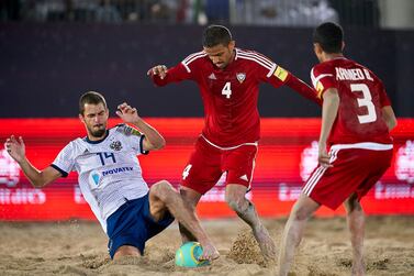 The UAE’s Waleed Beshr, centre, tussles for the ball in the third place playoff against Russia at the Intercontinental Beach Soccer Cup at Kite Beach in Dubai on Saturday. Manuel Queimadelos / Quality Sport Images