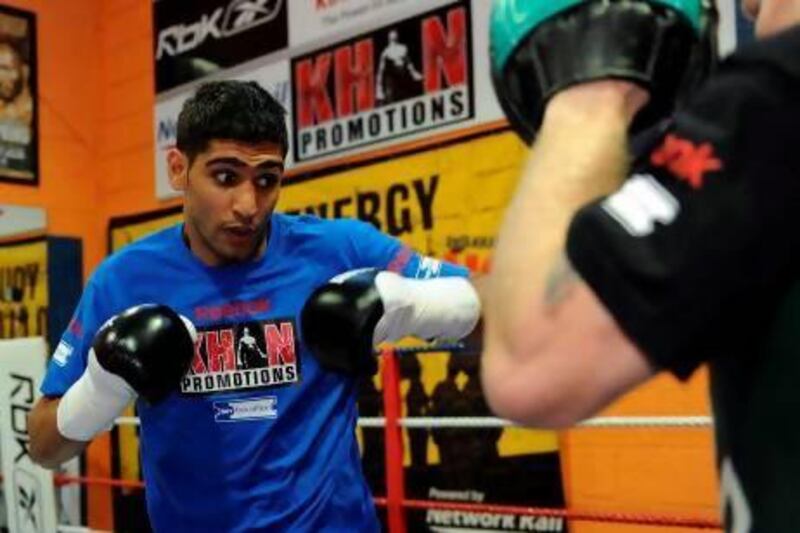 British boxer Amir Khan, shown here training at his gym in west England, is hoping Dubai will host his upcoming IBF welterweight championship bout against Devon Alexander. Paul Ellis / AFP