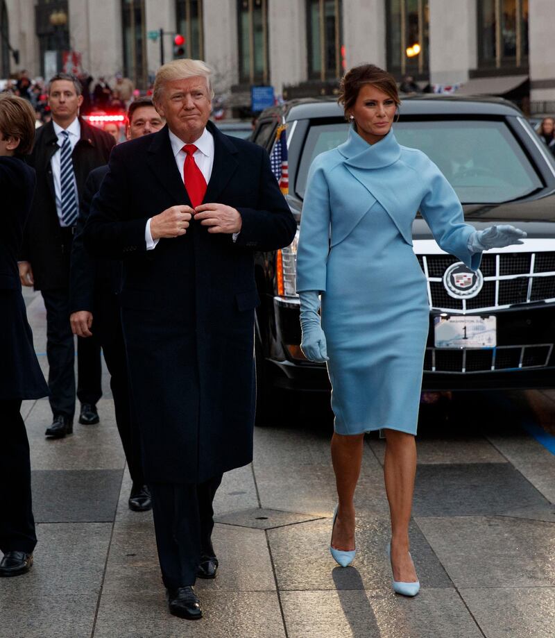 epa05736800 US President Donald J. Trump (L) walks with first lady Melania Trump (R) during the Inaugural Parade after he was sworn in as the 45th President of the United States in Washington, DC, USA, 20 January 2017. Trump won the 08 November 2016 election to become the next US President.  EPA/EVAN VUCCI / POOL