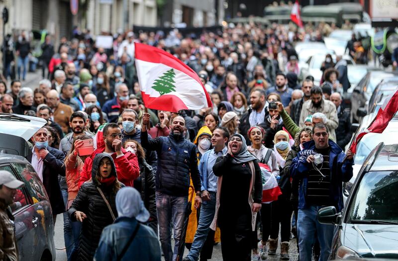 epa08260272 Anti-government protesters shout slogans demanding a new electoral law with early elections next to the parliament building in central Beirut, Lebanon, 29 February 2020. The demonstrators gathered in the Al-Barbir area and marched down several neighborhoods in a protest rejecting the new government recently formed by Prime Minister Hassan Diab.  EPA/EPA-EFE/NABIL MOUNZER