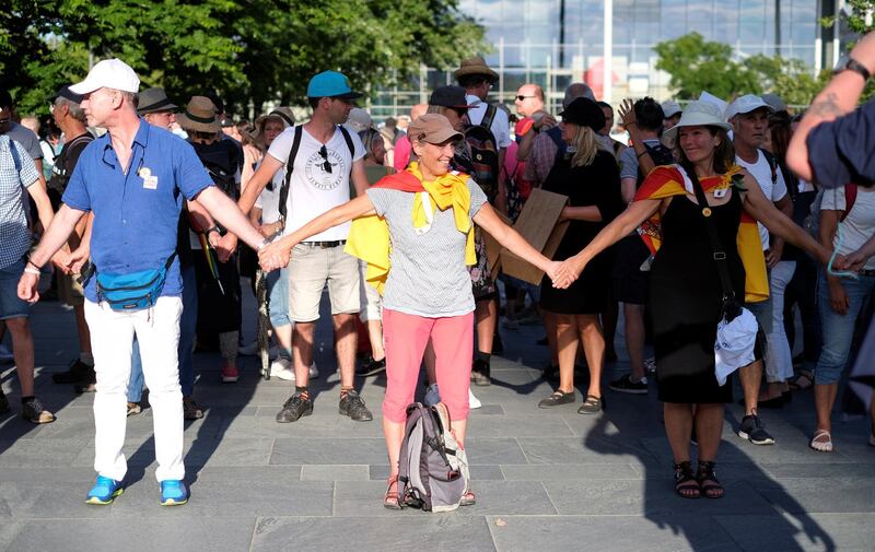 People form a human chain near the Chancellery during a protest against the government's restrictions amid the coronavirus disease (COVID-19) outbreak, in Berlin, Germany. REUTERS