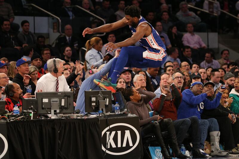 Philadelphia 76ers center Joel Embiid leaps over the front row of the crowd to save a ball from going out of bounds during an NBA game at Madison Square Garden, New York City. Reuters