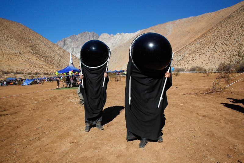 Chileans watch the sky with special suits prior to a total solar eclipse in Paiguano, Chile. Getty Images