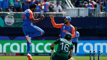 India's Jasprit Bumrah (L) celebrates after dismissing Pakistan's Mohammad Rizwan during the ICC men's Twenty20 World Cup 2024 group A cricket match between India and Pakistan at Nassau County International Cricket Stadium in East Meadow, New York on June 9, 2024.  (Photo by TIMOTHY A.  CLARY  /  AFP)