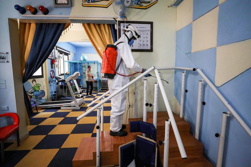 A member of the Syrian Civil Defence, also known as the 'White Helmets' disinfects a room at a physiotherapy centre in Syria's rebel-held northwestern city of Idlib.  AFP