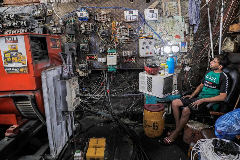 An electric switchboard technician keeps an eye on power-generating equipment in a Baghdad suburb where the national electricity grid is struggling to cope with the power demand caused by a severe heatwave.