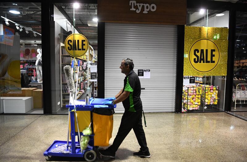 epa08374463 A cleaner walks through a deserted outlet centre in Brisbane, Australia, 21 April 2020. The vast majority of shops in the centre have closed their doors due to the COVID-19 pandemic.  EPA/DAN PELED AUSTRALIA AND NEW ZEALAND OUT