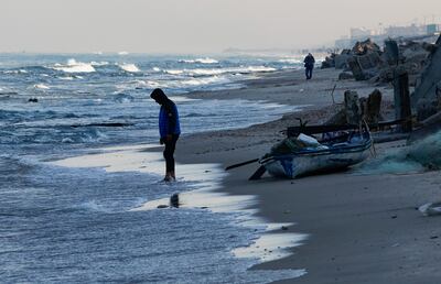 A man stands in front of a fishing boat at the beach, amid the continuing conflict between Israel and Hamas, in Rafah, in the southern Gaza Strip. Reuters