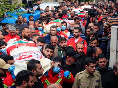 People carry the coffins of paramedics killed in an Israeli air strike during a funeral procession in Habariyeh, south Lebanon. AP