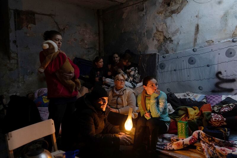 People settle in a bomb shelter in Mariupol. AP Photo