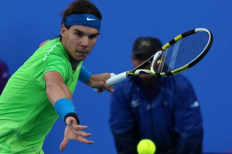 Abu Dhabi, United Arab Emirates, Dec 31 2011, Mubadala World Tennis Championship, Eugene  Story- Rafael Nadal returns a volley to Rodger Federer (not Shown) during their Consulation Match at the  Mubadala World Tennis Championship which was held at the Abu Dhabi International Tennis Complex at Zayed sports City.   Mike Young / The National 