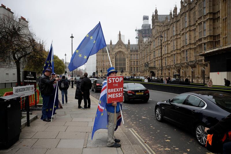 Anti-Brexit supporter Steve Bray from south Wales, protests outside the Houses of Parliament in London, Thursday Nov. 15, 2018. A pro-Brexit group of Conservative lawmakers says one of its leaders, Jacob Rees-Mogg, is formally calling for a vote of no-confidence in Prime Minister Theresa May. Two British Cabinet ministers, including Brexit Secretary Dominic Raab, resigned Thursday in opposition to the divorce deal struck by Prime Minister Theresa May with the EU â€” a major blow to her authority and her ability to get the deal through Parliament. (AP Photo/Matt Dunham)