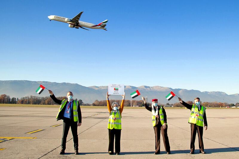 Up and away - Emirates staff in Geneva wave an Emirates flight off with UAE flags. 