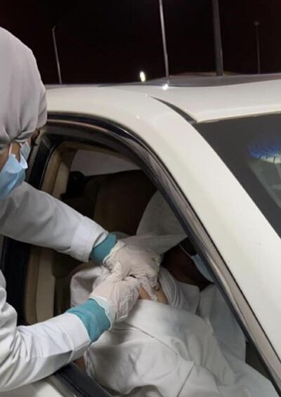 A nurse administers a dose of Covid-19 vaccine at a drive-through centre. Saudi Arabia's Ministry of Health