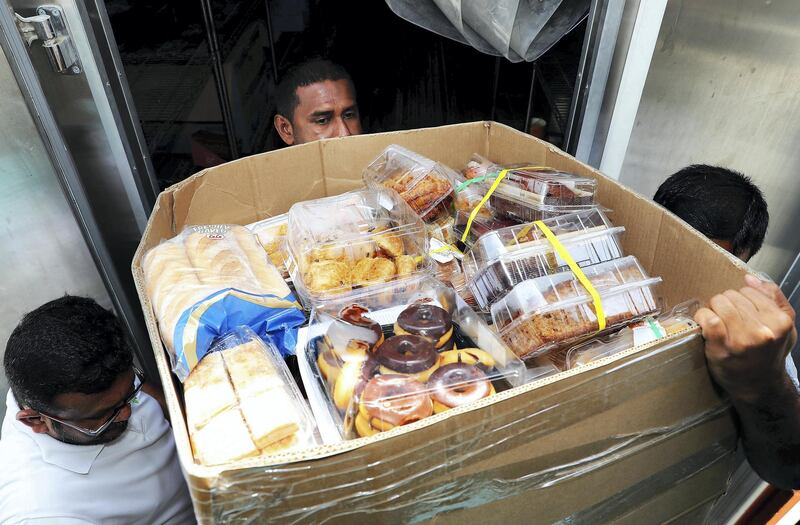 DUBAI , UNITED ARAB EMIRATES , JULY 11 – 2018 :- Workers loading the UAE Food Bank in Al Quoz with food stuff collected from different supermarkets , hotels and bakeries in Dubai.  ( Pawan Singh / The National )  For News. Story by Patrick Ryan
