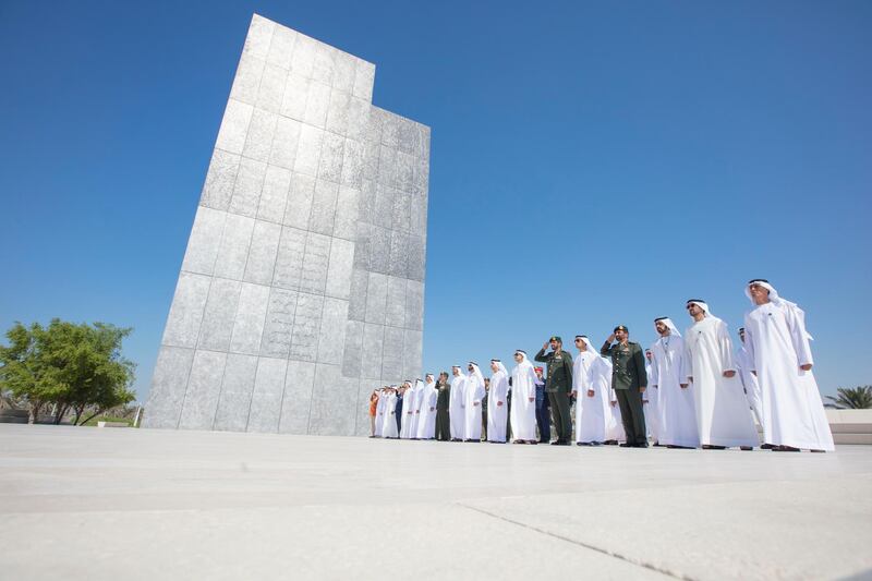 ABU DHABI, UNITED ARAB EMIRATES - November 30, 2017: HE Jaber Al Suwaidi, General Director of the Crown Prince Court - Abu Dhabi (R), HE Mohamed Mubarak Al Mazrouei, Undersecretary of the Crown Prince Court of Abu Dhabi (2nd R), HH Sheikh Khalifa bin Tahnoon bin Mohamed Al Nahyan, Director of the Martyrs' Families' Affairs Office of the Abu Dhabi Crown Prince Court (3rd R), HH Sheikh Khaled bin Zayed Al Nahyan, Chairman of the Board of Zayed Higher Organization for Humanitarian Care and Special Needs (ZHO) (5th R), HE Brigadier General Saleh Mohamed Saleh Al Ameri, Commander of the UAE Ground Forces (6th R), HH Sheikh Abdullah bin Zayed Al Nahyan, UAE Minister of Foreign Affairs and International Cooperation (7th R), HH Sheikh Hazza bin Zayed Al Nahyan, Vice Chairman of the Abu Dhabi Executive Council (8th R), HE Mohamed Ahmad Al Bowardi, UAE Minister of State for Defence Affairs (9th R), HH Sheikh Mohamed bin Zayed Al Nahyan, Crown Prince of Abu Dhabi and Deputy Supreme Commander of the UAE Armed Forces (10th R), HE Lt General Hamad Thani Al Romaithi, Chief of Staff UAE Armed Forces (11th R), HH Sheikh Saeed bin Zayed Al Nahyan, Abu Dhabi Ruler's Representative (12th R), HH Lt General Sheikh Saif bin Zayed Al Nahyan, UAE Deputy Prime Minister and Minister of Interior (13th R), HH Sheikh Mansour bin Zayed Al Nahyan, UAE Deputy Prime Minister and Minister of Presidential Affairs (14th R), HE Major General Essa Saif Al Mazrouei, Deputy Chief of Staff of the UAE Armed Forces (15th R), HH Sheikh Hamed bin Zayed Al Nahyan, Chairman of the Crown Prince Court of Abu Dhabi and Abu Dhabi Executive Council Member (16th R), Rear Admiral Pilot HH Sheikh Saeed bin Hamdan bin Mohamed Al Nahyan, Commander of the UAE Naval Forces (17th R), HH Sheikh Omar bin Zayed Al Nahyan, Deputy Chairman of the Board of Trustees of Zayed bin Sultan Al Nahyan Charitable and Humanitarian Foundation (18th R) and HE Major General Abdullah Muhair Al Ketbi (19th R), observe a moment of silence during 