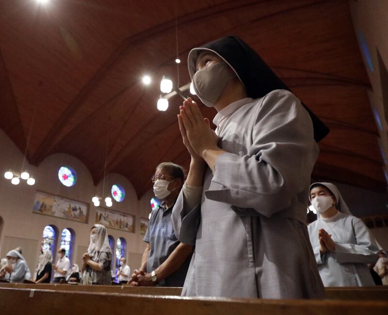 Churchgoers pray during an early morning mass at Urakami Cathedral in Nagasaki to mark the 76th anniversary of the atomic bombing of the Japanese city on August 9, 1945.