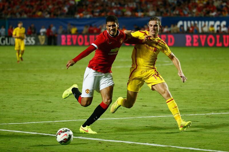 Chris Smalling, left, of Manchester United is challenged by Jordan Henderson of Liverpool in the Guinness International Champions Cup 2014 Final at Sun Life Stadium on August 4, 2014 in Miami Gardens, Florida. Chris Trotman/Getty Images