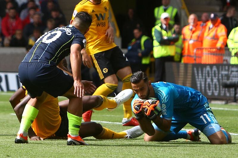 Wolverhampton Wanderers' Portuguese goalkeeper Rui Patricio, right, saves the ball in front of Aguero. AFP