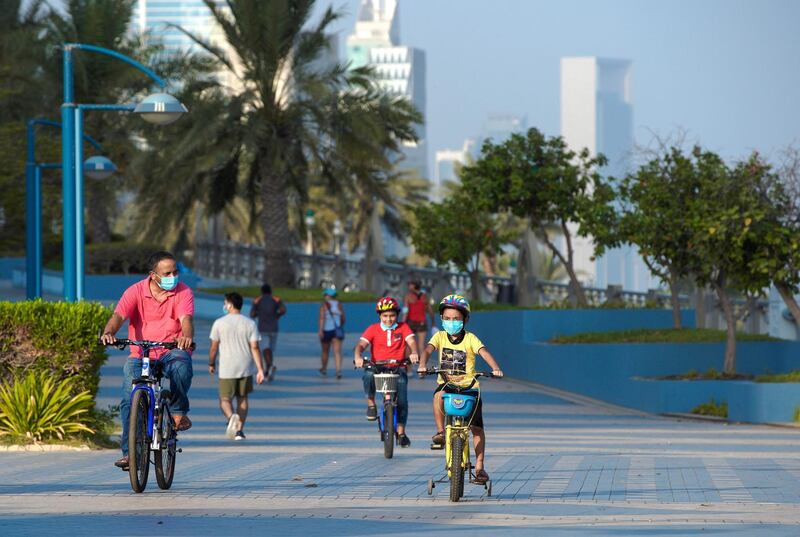 Abu Dhabi, United Arab Emirates, July 10, 2020.   
 A father and his son's enjoy a bike ride along the Corniche on a Friday morning.
Victor Besa  / The National
Section:  Standalone
Reporter: