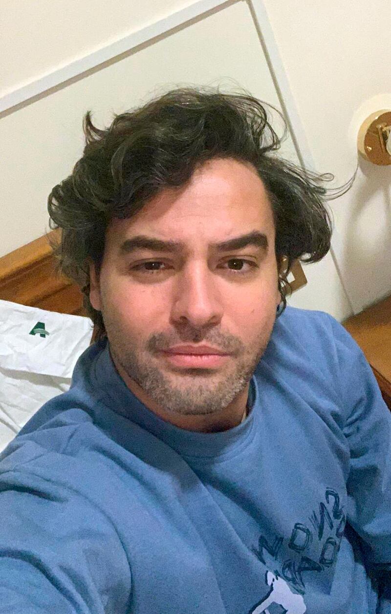 Andrea Napoli, 33, takes a selfie in a hotel being used for patients recovering from coronavirus, in Rome, Sunday, March 29, 2020. Andrea Napoli, a lawyer in Rome, developed a cough and fever less than a week after Italy's premier locked down the entire nation, including the capital which had continued life as usual while the virus raged in the north. He received a positive diagnosis for COVID-19 three days later. Initially, Napoli was told to quarantine at home with the warning that his condition could deteriorate suddenly, and it did. By the next day, he was hospitalized in intensive care, with X-rays confirming he had developed pneumonia. (Andrea Napoli via AP)