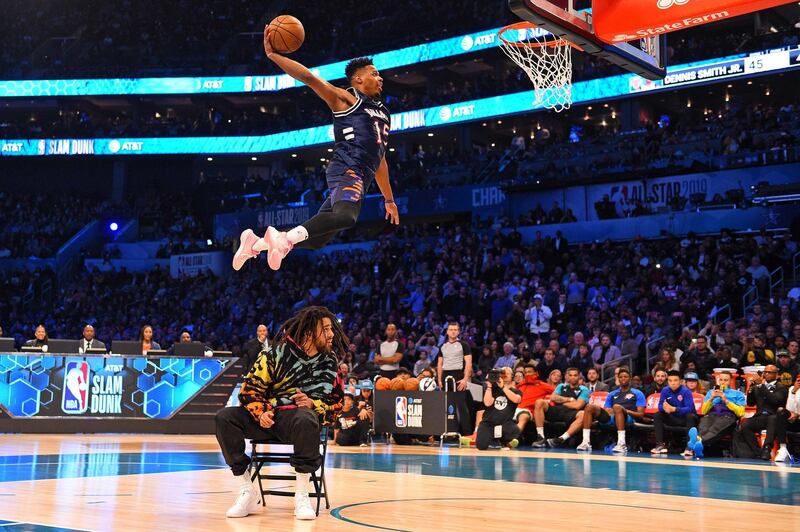 New York Knicks forward Dennis Smith Jr dunks over J Cole in the NBA Slam Dunk Contest in Charlotte, North Carolina. Reuters