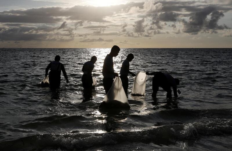 Policemen collect trash in the waters off the beach at the holiday island of Boracay during the first day of a temporary closure for tourists. Erik De Castro / Reuters