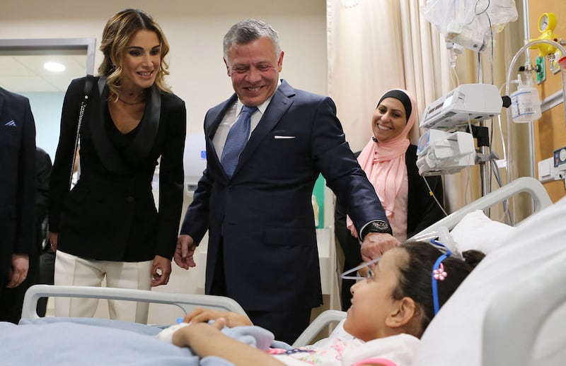 King Abdullah and Queen Rania visit a young patient as they mark the expansion of the King Hussein Cancer Centre in Amman. AFP