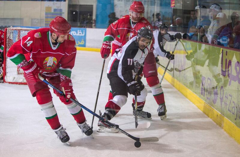 ABU DHABI, UNITED ARAB EMIRATES - Mobarak Al Mazrouei(11) AD Storms caught between Ponomarev Stepan(14) and Hiebau Andrei(16) of Belarus at the AD Storms vs Belarus final game at the Ice Hockey President Cup 2018, Zayed Sport City Ice Rink, Abu Dhabi.  Leslie Pableo for The National