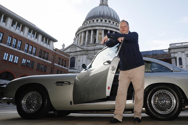 Andy Palmer, chief executive officer of Aston Martin Lagonda Global Holdings Plc, poses for a photograph with an Aston Martin DB5 automobile outside the London Stock Exchange in London, U.K., on Wednesday, Oct. 3, 2018. Aston Martin is expected to price its U.K. initial public offering at 19 pounds ($24.66) per share, toward the bottom of a marketed range that it had already narrowed, according to people familiar with the matter. Photographer: Luke MacGregor/Bloomberg