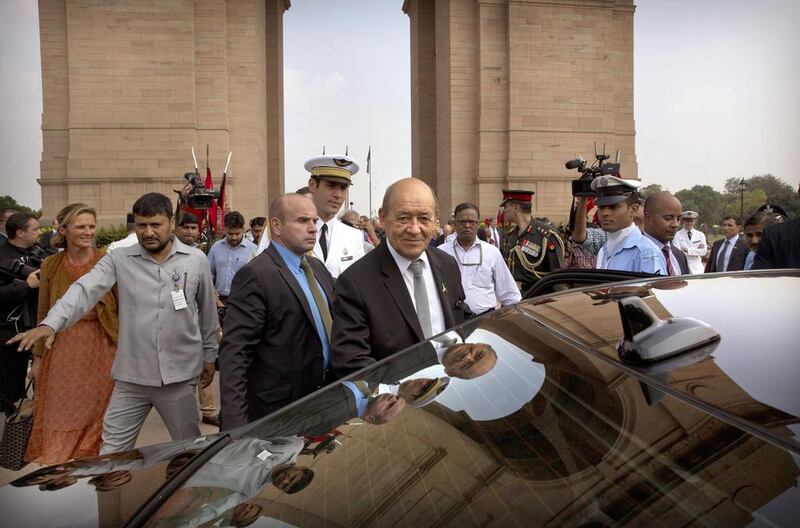 French defence minister Jean Yves Le Drian, centre, paid his respects at the India Gate war memorial in New Delhi, India, on September 23, 2016. The minister was in India to sign a deal for the purchase of 36 French-made Rafale fighter jets. Manish Swarup / Associated Press
