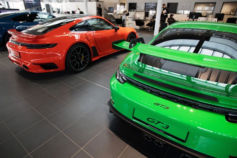 A Porsche 911 turbo, left, and a GT3 luxury car at a showroom in Berlin. Bloomberg