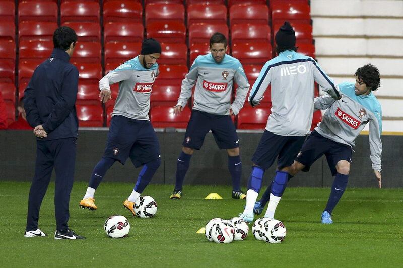 From left to right, Portugal's Ricardo Quaresma, Joao Moutinho, Bruno Alves and Tiago kick around during a team training session on Monday night at Manchester United's Old Trafford grounds. Jose Sena Goulao / EPA