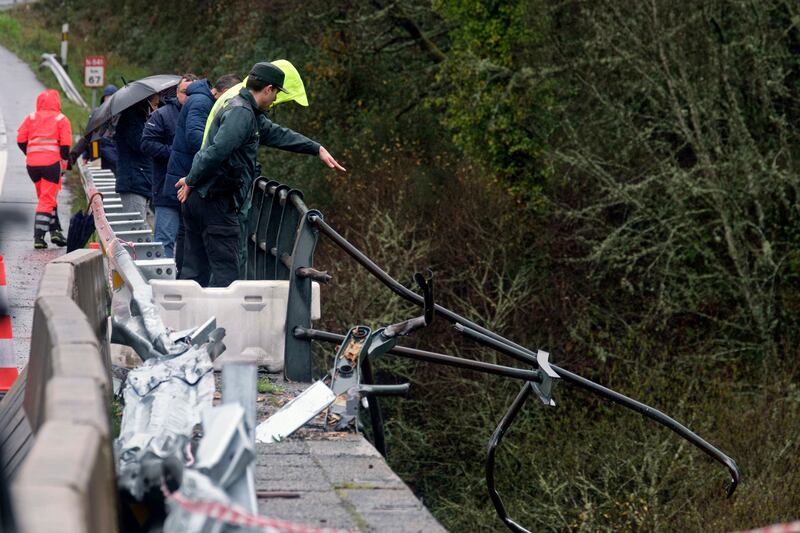 Emergency services were alerted by a motorist who saw a broken railing on the bridge as he drove in heavy rain. AP