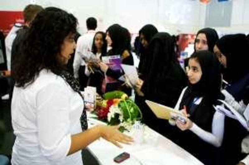 01/11/2009 - Abu Dhabi, UAE -   Basant Hasanin, Marketing Assistant for Vocational Education and Training Institutes (VETI), left, speaks with Mai Abdul Kader, 16, of Egypt, middle, about job opportunities during a career fair at the Higher Colleges of Technology campus in Madinat Zayed on Sunday November 1, 2009.  The career fair and employment forum discussed opportunities to learn and work in the Western Region.  (Andrew Henderson / The National)
 *** Local Caption ***  ah_091101_Career_Fair_0072.jpg