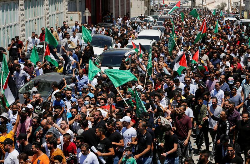 People attend the funeral of Palestinian activist Nizar Banat in Hebron on June 25, 2021, a day after he died in the custody of Palestinian Authority security forces. Reuters