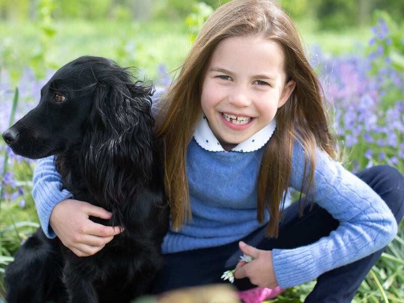 Princess Charlotte with cocker spaniel Orla in a photograph taken by her mother, the Duchess of Cambridge, in Norfolk, at the weekend. PA