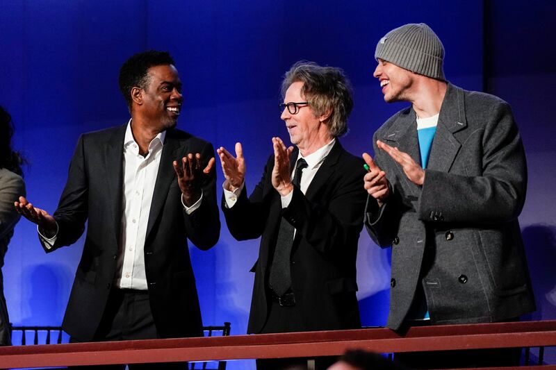 Comedians and actors Chris Rock, Dana Carvey and Pete Davidson applaud. Reuters