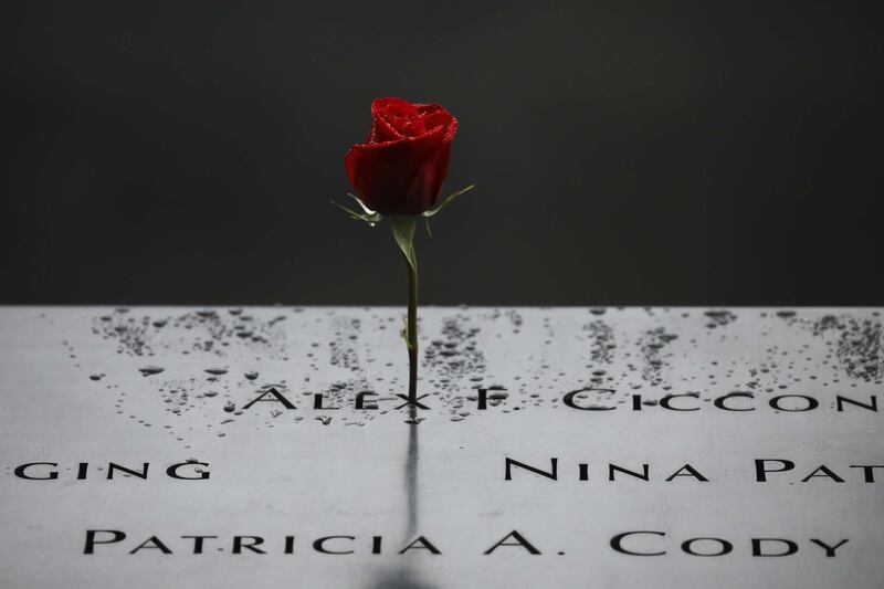 A flower stands along the north pool at the National September 11 Memorial in New York City. AFP